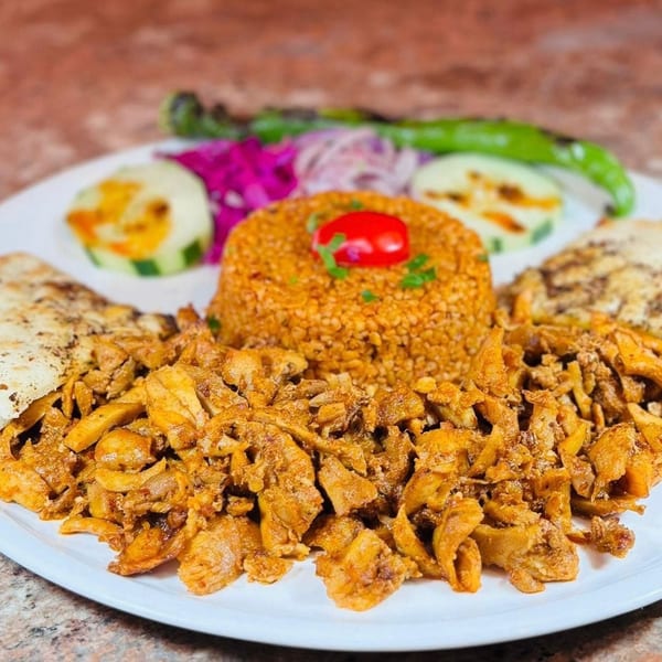Koy Grill's Mediterranean dish with seasoned chicken, bulgur pilaf, grilled vegetables, and flatbread.