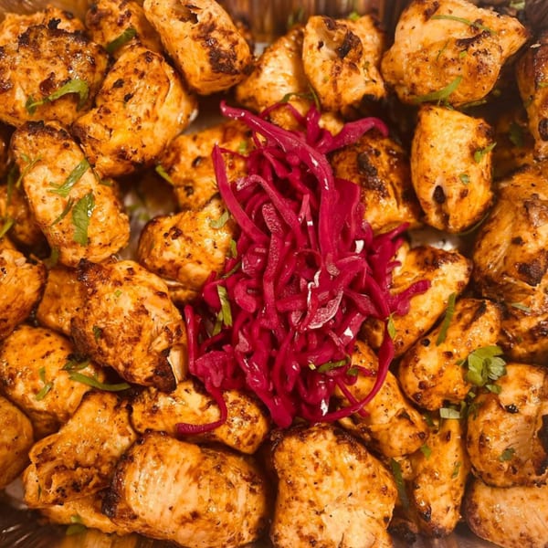 Close-up of Koy Grill's Mediterranean chicken shish tawook with pickled red cabbage.